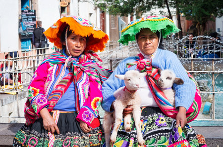 CUSZO, PERU - MARCH 18, 2015: Peruvian woman in traditional dresses pose  for tourists in Cuzco, Peruのeditorial素材