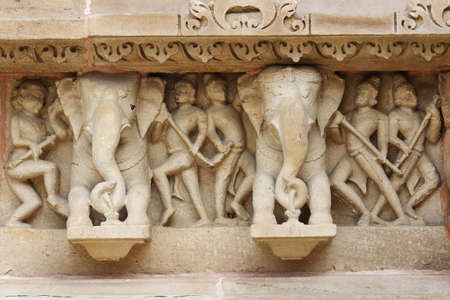 Stone carved  bas-relief in Hindu temple in Khajuraho, India.の写真素材