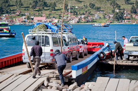 TITICACA LAKE, BOLIVIA - APR 05, 2015: Ferry service on lake Titicaca between the towns of San Pedro de Tiquina and San Pablo de Tiquina.のeditorial素材