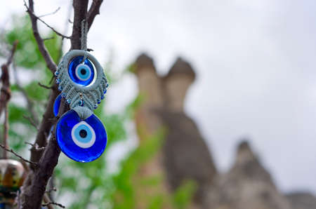 A nazar, charms to ward off the evil eye , on the branches of a tree in Cappadocia, Turkeyの写真素材