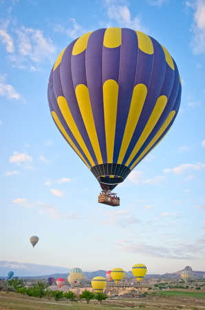 Hot air balloons over mountain landscape in Cappadocia, Goreme National Park Turkey.の写真素材