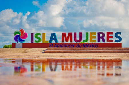 colorful inscription Isla Mujeres (Island of the Women) on caribbean sea coast, Mexicoの写真素材