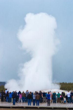 Yellowstone National Park, USA- May 20, 2017: Tourists watching Old Faithful geyser erupting in Yellowstone National Parkのeditorial素材