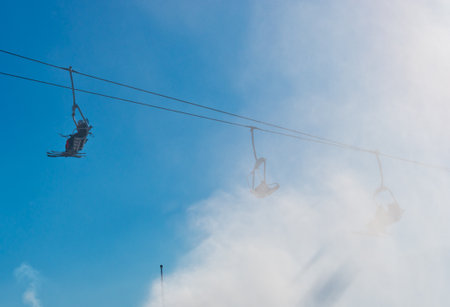 Bukovel, Ukraine - December 31, 2015: Skiers and snowboarders on a ski lift in Bukovel. Bukovel is the most popular Ukranian mountain resort.のeditorial素材