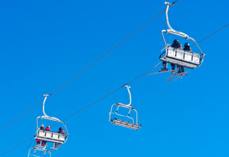 Bukovel, Ukraine - December 31, 2015: Skiers and snowboarders on a ski lift in Bukovel. Bukovel is the most popular Ukranian mountain resort.のeditorial素材