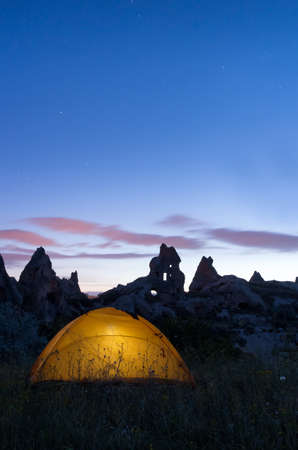 Yellow tent under the night sky. Mountain landscape in Cappadocia,Turkey.の写真素材