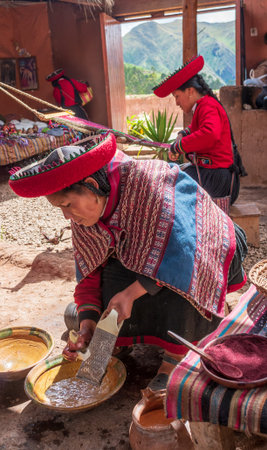 Chinchero, Peru - March 9, 2015: Peruvian woman dressed in traditional clothes while working on a...