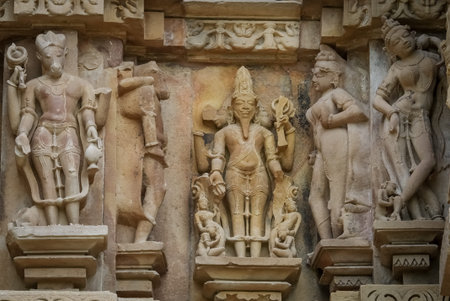 Stone carved erotic bas relief in Hindu temple in Khajuraho, India.
