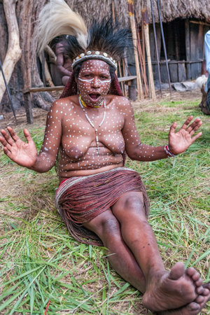 Papua Province, Indonesia -December 28, 2010: The woman of a Papuan tribe in traditional clothes and coloring at New Guinea Islandのeditorial素材
