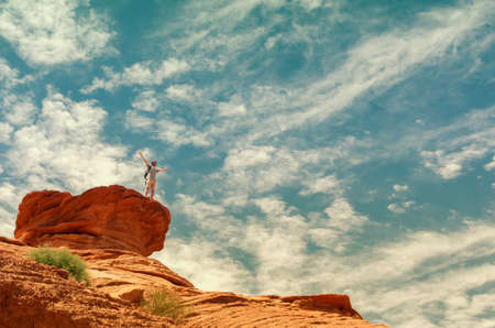 Hiker in mountains against the dramatic skyの写真素材