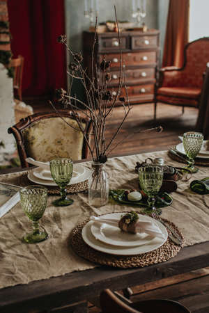 Indoor vintage composition of old furniture, dry branch and some dishesの写真素材