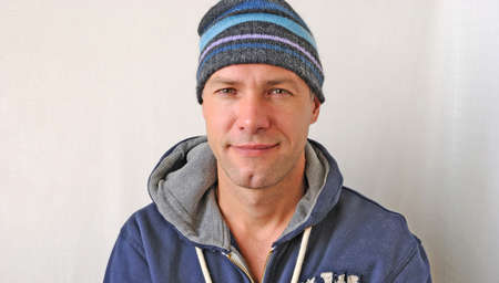 Portrait of the smiling man wearing a knitted hatの写真素材