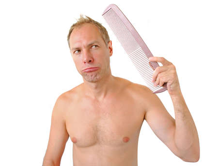 Bewildered man hand holding comb on the headの写真素材