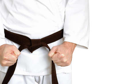 Man in a kimono and belt for martial arts on the white backgroundの写真素材