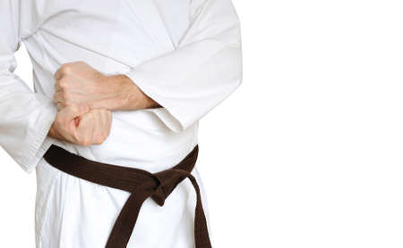 Man in a kimono and belt for martial arts on the white backgroundの写真素材