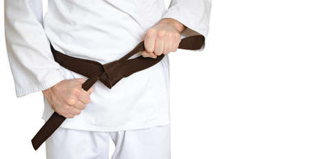 Man in a kimono and belt for martial arts on the white backgroundの写真素材