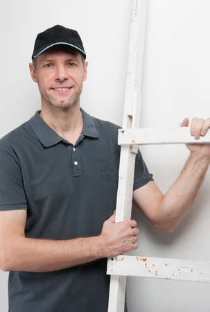 Worker man hold a ladderの写真素材