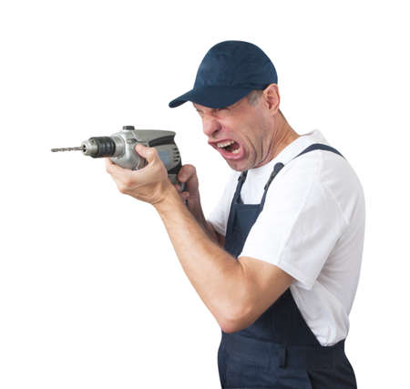 Portrait of worker in blue uniform with drill isolated on white backgroundの写真素材