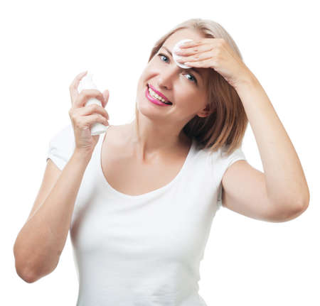 Woman removes makeup sponge isolated on white backgroundの写真素材