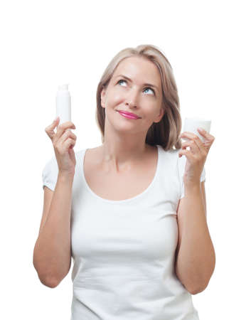 Beautiful woman chooses for skin care creamの写真素材