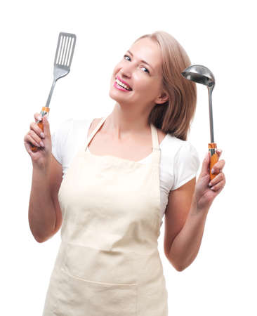 Beautiful housewife with ladle and spatula. Isolated on white backgroundの写真素材