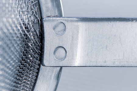 Close up of rivets on metal sieveの写真素材