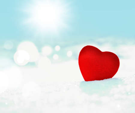 red heart on a background of white snow and skyの写真素材