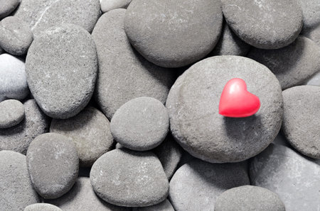 Red hearts on pebble stones, still life. Valentine's Day backgroundの写真素材