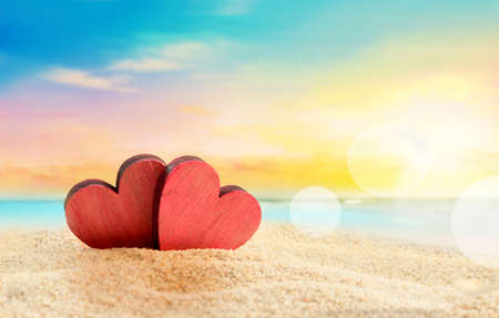 Two wooden red hearts on the summer beachの写真素材