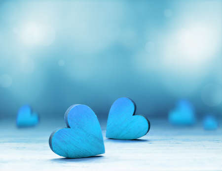 Wooden heart on blue background. Valentines Day.の写真素材