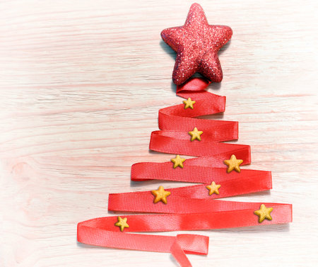 Abstract christmas tree made from red ribbon and starの写真素材