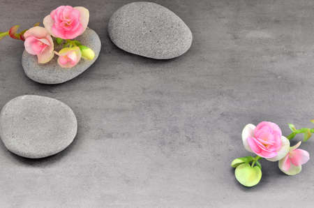 Beautiful flower and stone zen spa on grey backgroundの写真素材