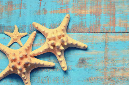 Starfish on a wooden blue background. Summer beach.の写真素材