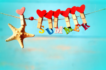 Starfish with letters hanging from clothespins on a blue background