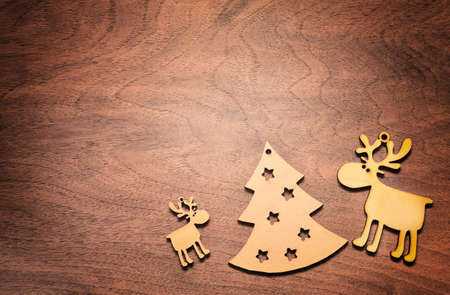 Christmas background with wooden christmas tree and deer. Wooden background.の写真素材
