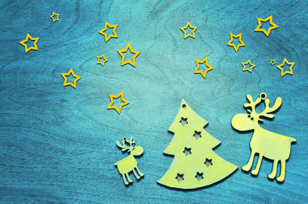 Christmas background with wooden christmas tree and deer. Blue background.の写真素材