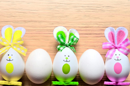 Colored easter egg bunny, wooden background. Happy Easter