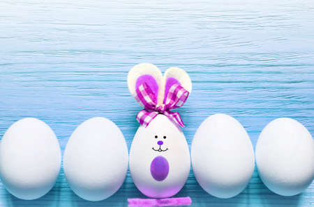 Colored easter egg bunny, wooden background. Happy Easterの写真素材