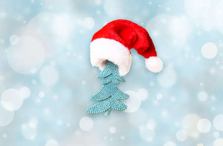 Christmas tree in Santa hat and Christmas decoration background.の写真素材