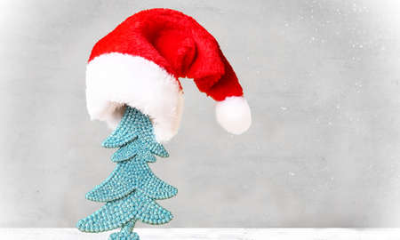 Christmas tree in Santa hat and Christmas decoration background.の写真素材
