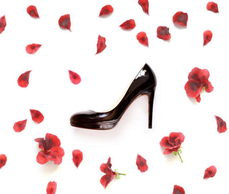 Top view a new of black stylish shoes and flowers isolated on whiteの写真素材