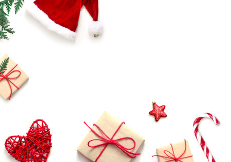 Christmas composition. Christmas gift, stars, Santa hat and fir tree branches. Top view, flat lay.