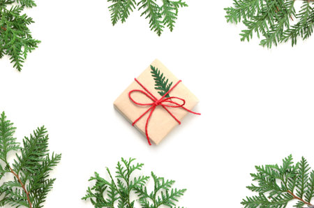 Christmas gift boxe and fir tree branch on white background. Top view with copy space.の写真素材