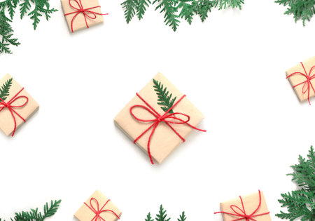 Christmas gift boxe and fir tree branch on white background. Top view with copy space.