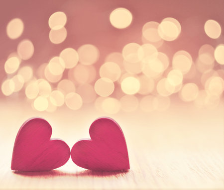 Hearts on a wooden table and background is a bokeh. valentines day concept.の写真素材