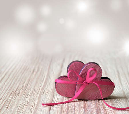Hearts on a wooden table and background is a bokeh. valentines day concept.の写真素材