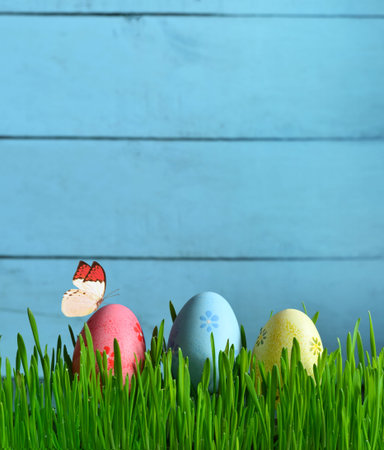 Painted Easter eggs in a green grass on a meadow. Happy Easter.