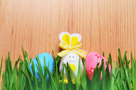 Easter funny bunny on green grass and easter eggs. Easter background