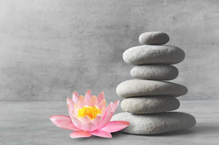 Stones and pink flower lotus balance. Zen and spa concept.の写真素材