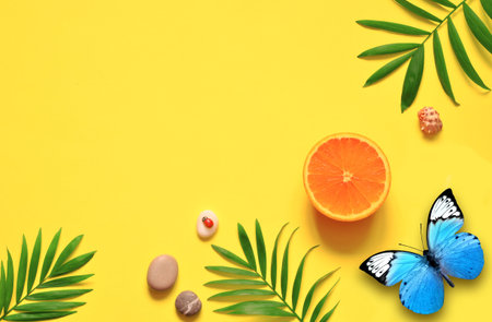 Tropical background. Palm trees branches with starfish and seashell on yellow background. Travel....